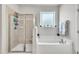 The bathroom features a glass-enclosed shower and a soaking tub under a window at 298 Hannah Yam Ln, Benson, NC 27504