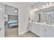 Bathroom showcasing dual sinks with a view into the primary bedroom at 298 Hannah Yam Ln, Benson, NC 27504