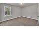 Bedroom with plush carpet and a window with backyard views for a tranquil setting at 298 Hannah Yam Ln, Benson, NC 27504