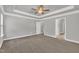 The spacious bedroom offers ample natural light, neutral walls, plush carpet, and modern fan at 298 Hannah Yam Ln, Benson, NC 27504