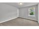 Bedroom showcasing neutral walls, carpeted floors, and a bright window offering natural light at 298 Hannah Yam Ln, Benson, NC 27504