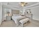 Bright primary bedroom showcasing an accent wall with a large bed and coordinated furnishings at 298 Hannah Yam Ln, Benson, NC 27504