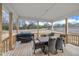Covered deck featuring outdoor dining table and grill overlooking a large fenced backyard at 298 Hannah Yam Ln, Benson, NC 27504