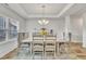 Elegant dining room with modern chandelier, trey ceiling, and decor at 298 Hannah Yam Ln, Benson, NC 27504