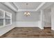 Formal dining room with wainscoting, a hanging chandelier, and luxury vinyl plank flooring at 298 Hannah Yam Ln, Benson, NC 27504
