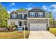 Charming two-story home with stone accents, inviting front porch, and manicured lawn at 298 Hannah Yam Ln, Benson, NC 27504