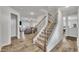 Inviting foyer with a staircase, hardwood floors, and view into the living room at 298 Hannah Yam Ln, Benson, NC 27504