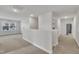 Upstairs hallway featuring neutral walls, carpeted floors, and bright windows at 298 Hannah Yam Ln, Benson, NC 27504