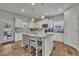 Bright kitchen with an island, pendant lighting, white cabinets, and modern appliances at 298 Hannah Yam Ln, Benson, NC 27504