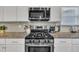 Modern kitchen with stainless steel appliances, granite countertops, and white cabinetry at 298 Hannah Yam Ln, Benson, NC 27504