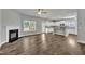 Bright and airy living room featuring a fireplace, hardwood floors, and an open layout to the kitchen at 298 Hannah Yam Ln, Benson, NC 27504