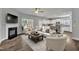 Open-concept living room featuring hardwood floors, a fireplace, and a seamless transition to the modern kitchen at 298 Hannah Yam Ln, Benson, NC 27504