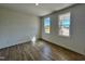 Bright bedroom with wood-look flooring, neutral walls, and well-lit by two windows at 302 Longbow Dr, Middlesex, NC 27557