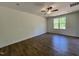 Neutral bedroom featuring hardwood floors, a ceiling fan, and a bright window at 302 Longbow Dr, Middlesex, NC 27557