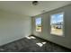 Bedroom featuring neutral carpeting, two windows with natural light, and a serene ambiance at 302 Longbow Dr, Middlesex, NC 27557