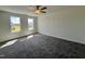 Spacious bedroom with plush carpet, two windows, and a neutral color palette at 302 Longbow Dr, Middlesex, NC 27557