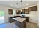 Modern kitchen featuring stainless steel appliances, granite countertops, and a convenient center island at 302 Longbow Dr, Middlesex, NC 27557