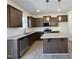 Modern kitchen featuring stainless steel appliances, granite countertops, and a convenient center island at 302 Longbow Dr, Middlesex, NC 27557