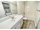 Clean bathroom with tub, vanity, and washer/dryer in the same room at 311 Gladstone Dr, Durham, NC 27703