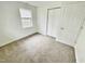 Bright bedroom with neutral carpeting and closet at 311 Gladstone Dr, Durham, NC 27703
