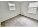 Spacious bedroom with neutral carpeting and two windows at 311 Gladstone Dr, Durham, NC 27703