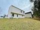 Rear view of a two story house with vinyl siding and a grassy yard at 311 Gladstone Dr, Durham, NC 27703