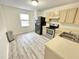 Kitchen with light wood cabinets, stainless steel appliances, and laminate flooring at 311 Gladstone Dr, Durham, NC 27703