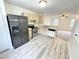 Open kitchen features stainless steel appliances and light wood cabinets at 311 Gladstone Dr, Durham, NC 27703