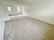 Large living room with neutral carpeting and exterior access at 311 Gladstone Dr, Durham, NC 27703