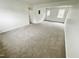 Spacious living area with carpet and doors leading outside at 311 Gladstone Dr, Durham, NC 27703
