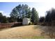 Ample backyard storage shed with wood fence at 36 Aster Ln, Pittsboro, NC 27312
