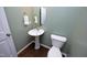 Small bathroom with pedestal sink and dark wood floors at 36 Aster Ln, Pittsboro, NC 27312