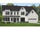 Two-story farmhouse style home with white siding, black trim, and a two-car garage at 809 Timber Mist Ct, Cary, NC 27519