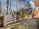 Stone patio and wooden deck with stairs leading to the backyard at 1 Pointe View Ct, Durham, NC 27713