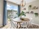 Bright dining area with hardwood floors, modern lighting, and access to outdoor patio at 103 Siebold St, Garner, NC 27529
