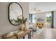 Inviting entryway featuring a console table with vases and a mirror, leading into the bright living area at 103 Siebold St, Garner, NC 27529