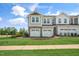 New townhome exteriors with attached garages, stone accents, and manicured landscaping offer value at 103 Siebold St, Garner, NC 27529