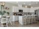 Bright kitchen features white cabinetry, granite countertops, a center island with seating, and modern stainless steel appliances at 103 Siebold St, Garner, NC 27529