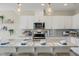 Modern kitchen with granite countertops, stainless steel appliances, white cabinets, and pendant lighting at 103 Siebold St, Garner, NC 27529