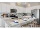 Stylish kitchen featuring white cabinets, granite countertops, stainless steel appliances, and modern pendant lighting at 103 Siebold St, Garner, NC 27529