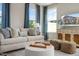 Cozy living area featuring comfortable seating, large windows with curtains, and a stylish coffee table at 103 Siebold St, Garner, NC 27529