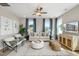 Comfortable living room showcasing modern furniture, large windows with blue curtains, and recessed lighting at 103 Siebold St, Garner, NC 27529