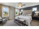 Serene bedroom with a plush king-sized bed, decorative headboard, and plenty of natural light from large windows at 103 Siebold St, Garner, NC 27529