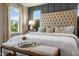 Inviting main bedroom with a tufted headboard, luxurious bedding, and a tray table for an elegant touch at 103 Siebold St, Garner, NC 27529