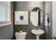 Stylish powder room featuring elegant fixtures, attractive art, and wainscoting, adding a touch of luxury at 103 Siebold St, Garner, NC 27529