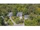 Aerial view of home nestled in a tree-lined neighborhood with lush landscaping at 106 Dairy Ct, Chapel Hill, NC 27516