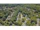 Aerial view of the community featuring mature trees, picturesque streets, and tranquil lake in background at 106 Dairy Ct, Chapel Hill, NC 27516