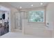 Bathroom featuring a glass shower, large soaking tub and walk-in closet at 106 Dairy Ct, Chapel Hill, NC 27516