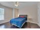 Neutral bedroom featuring dark wood floors, ceiling fan, and lots of natural light at 106 Dairy Ct, Chapel Hill, NC 27516