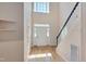 Bright entryway with hardwood floors, staircase, and high ceilings at 106 Dairy Ct, Chapel Hill, NC 27516
